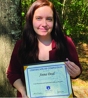 Anna Deal holding Certificate of Completion for the online Court Reporting program