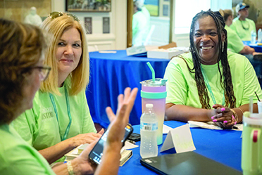 Three women sitting at a table talking
