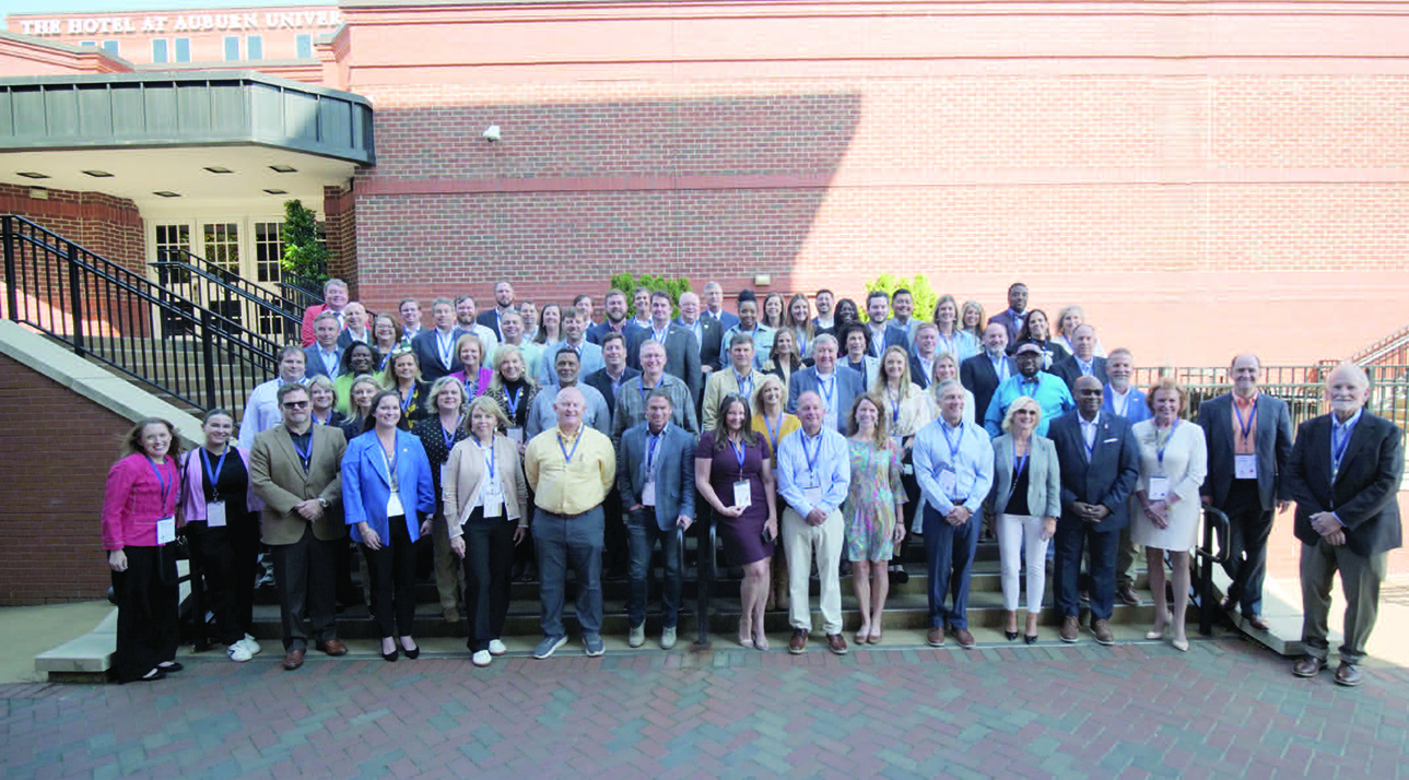 Members of the Intensive Economic Development Training Course reunion gather for a group photo.