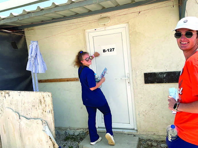 Greece Service-Learning Program students go door to door at a refugee camp outside of Athens