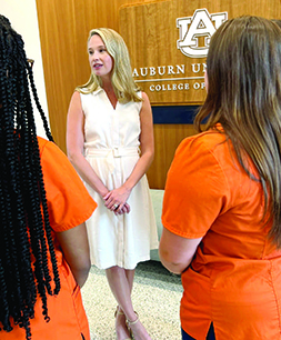 Kendall Henderson talking to two nursing students.