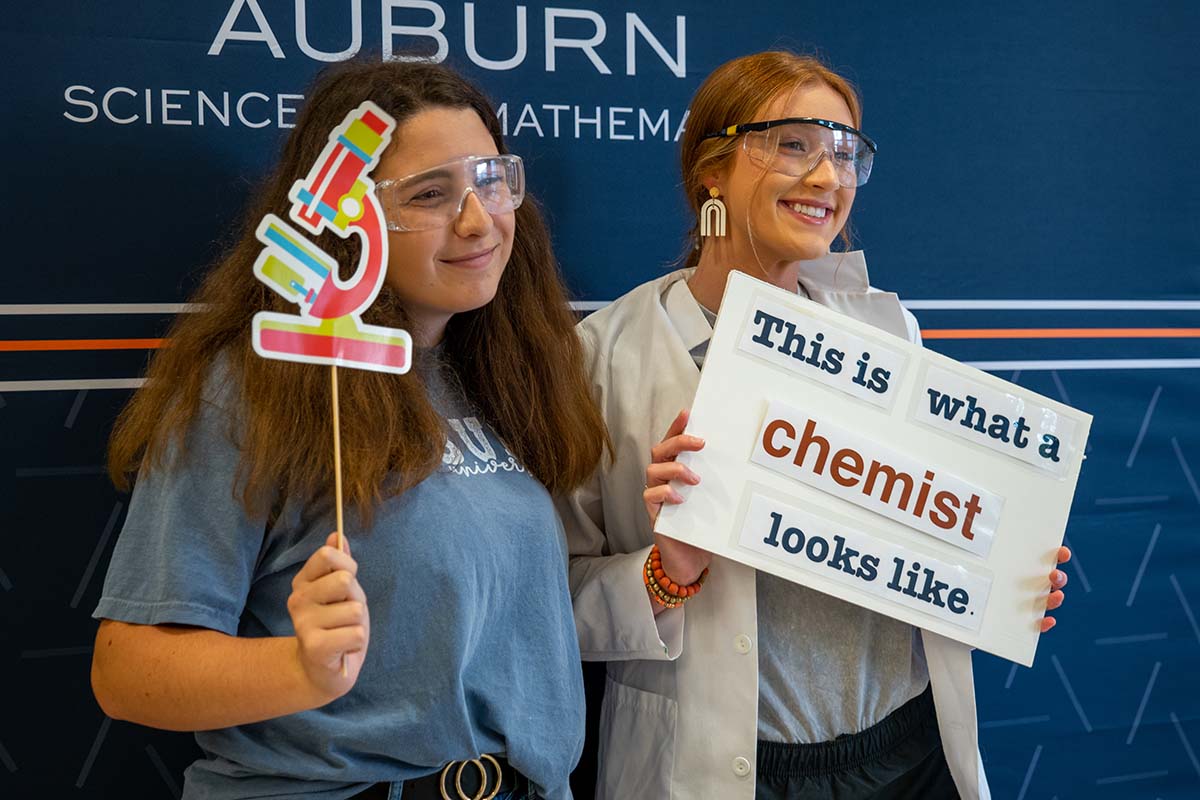 College of Sciences and Mathematics chemist students wearing lab coats