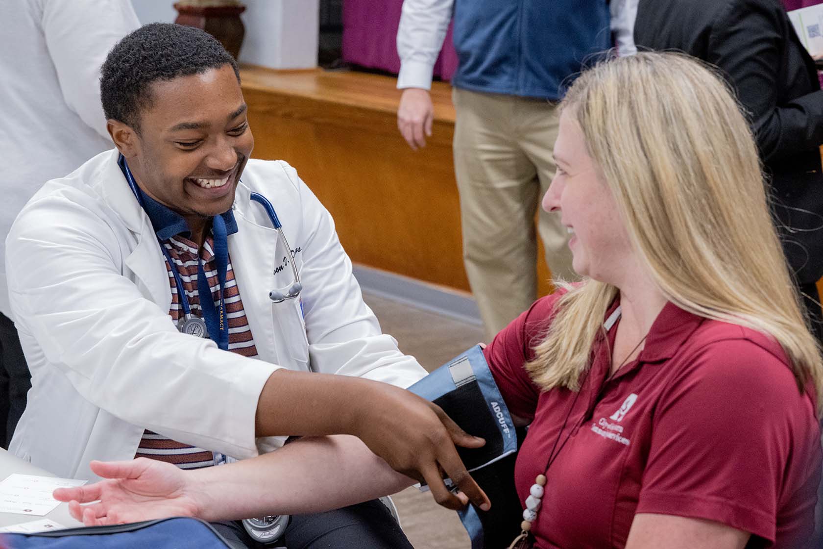 College of Pharmacy student testing blood pressure on lecturer
