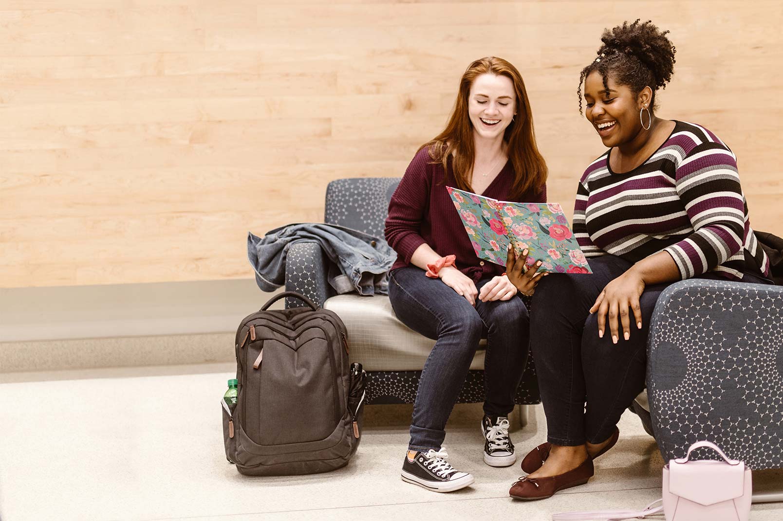 Two students look at a notebook together