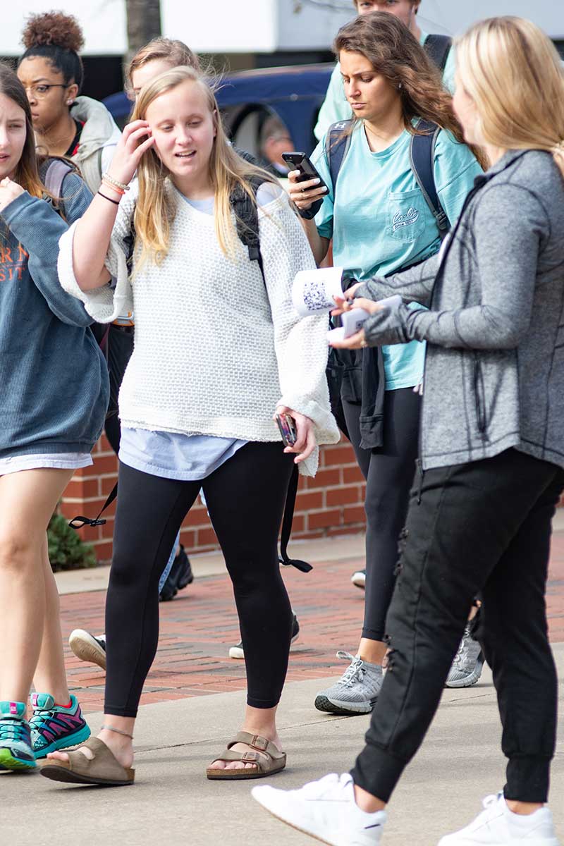 Several students walk on campus