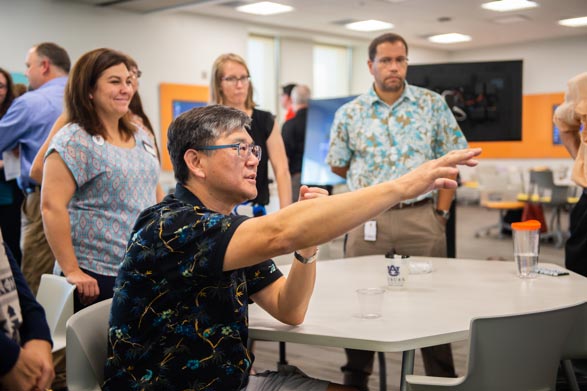 A man points to a white board