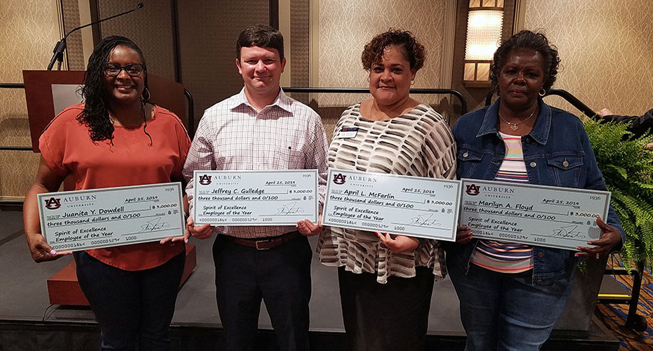 four award winners standing