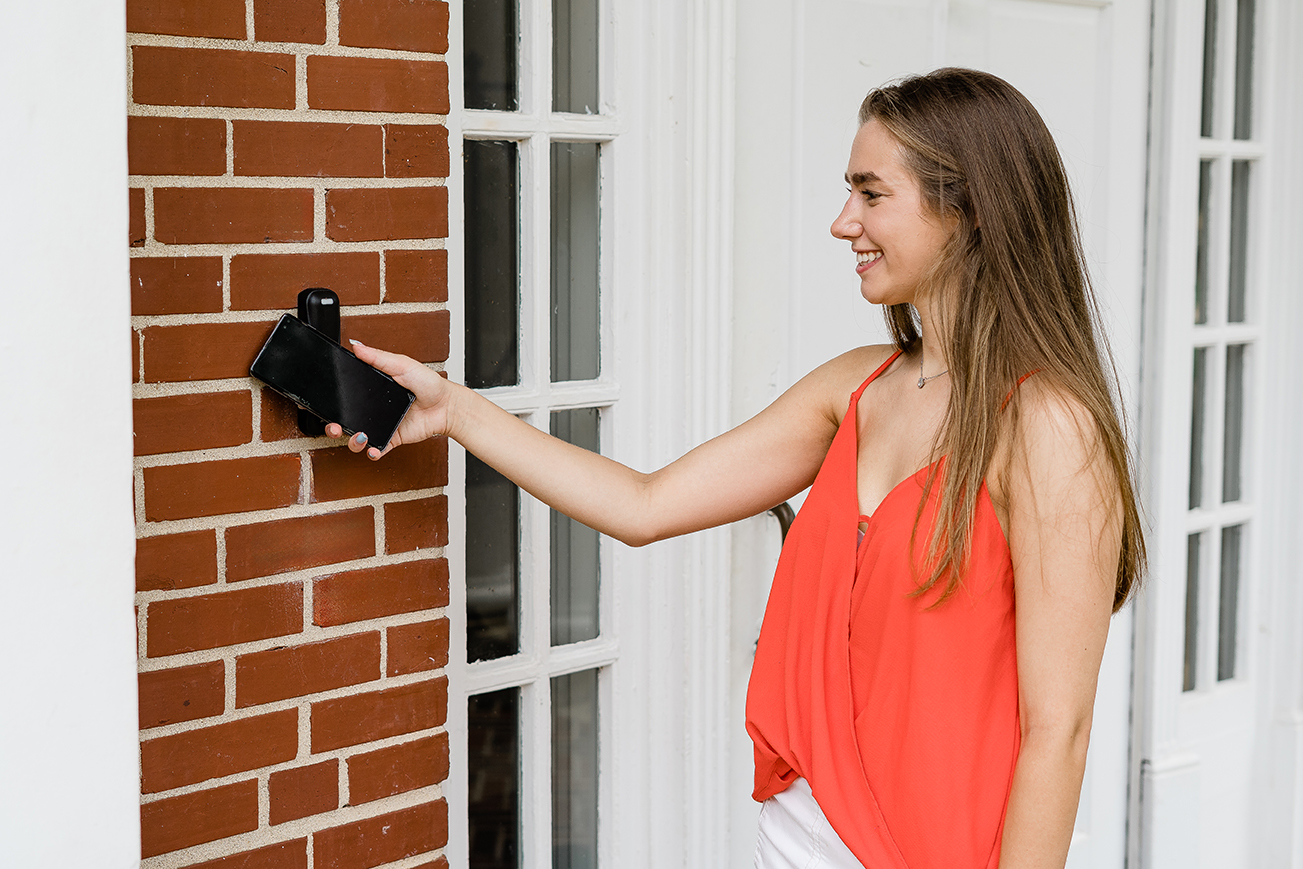 A student holds his phone by a scanner