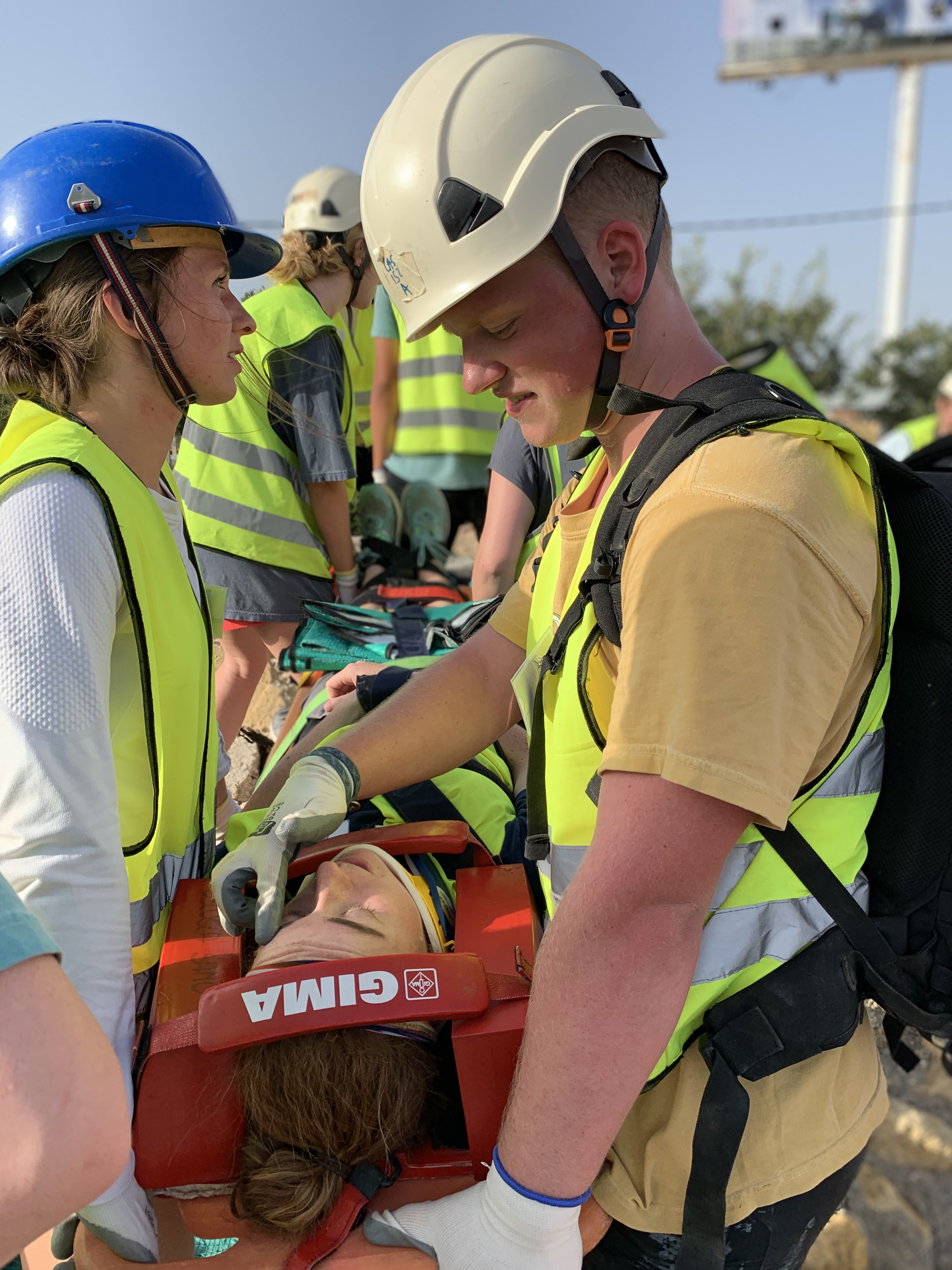 Students providing first-aid in a staged emergency situation.