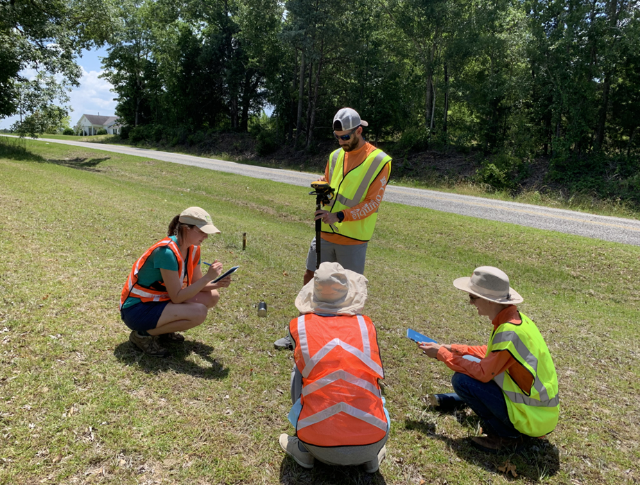 Students using GPS software to find unmarked graves. 