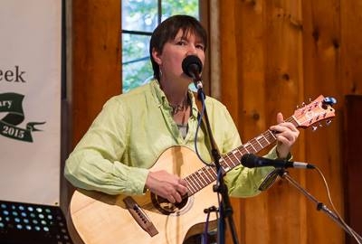 Catherine Jahncke playing a guitar that she built. 