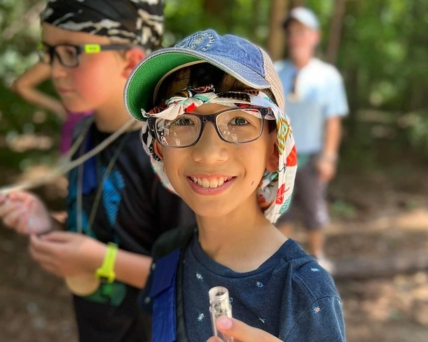 Close up of student in the field smiling at the camera