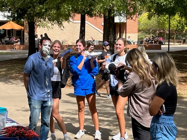 Matt Kearley takes a pie to his face thrown by his students to the right to help end hunger in East Alabama.