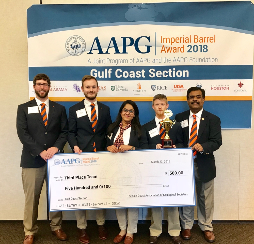 Geosciences students with Dr. Uddin holding a giant check