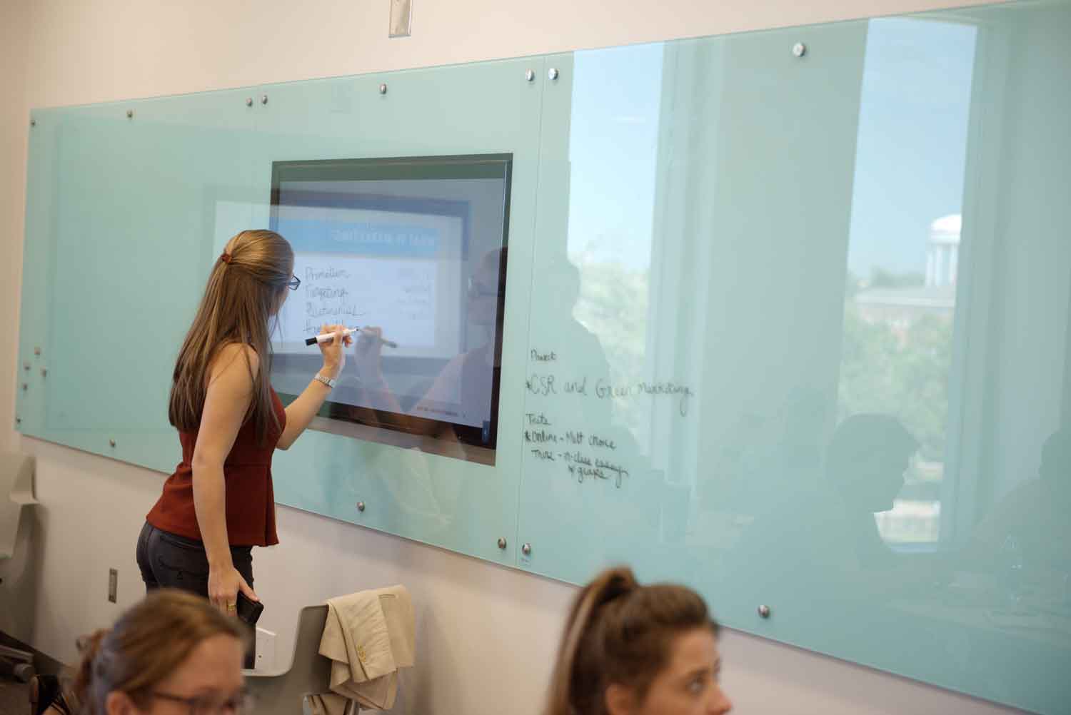 Student writing on screen in Mell classroom.