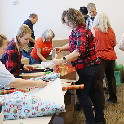 OIT staff members wrapping boxes to donate to US Troops