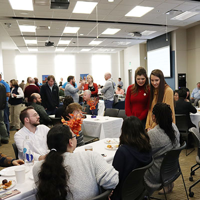 SGA president talking with student IT employees at the IT community annual meeting
