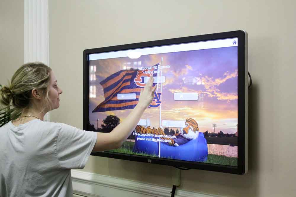 A student looking through the interactive screen