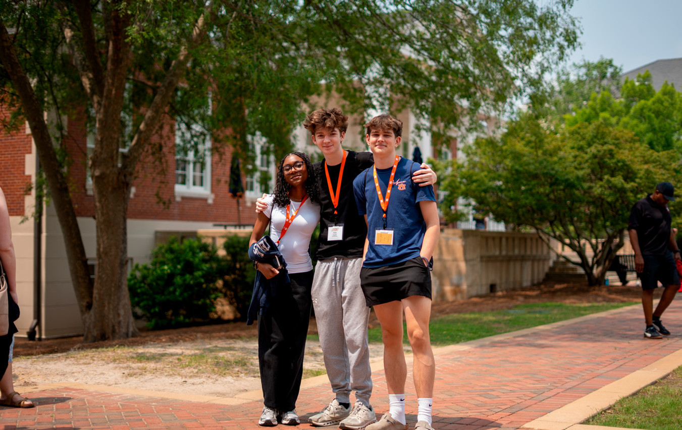 Three students walking on campus during Summer Scholars.