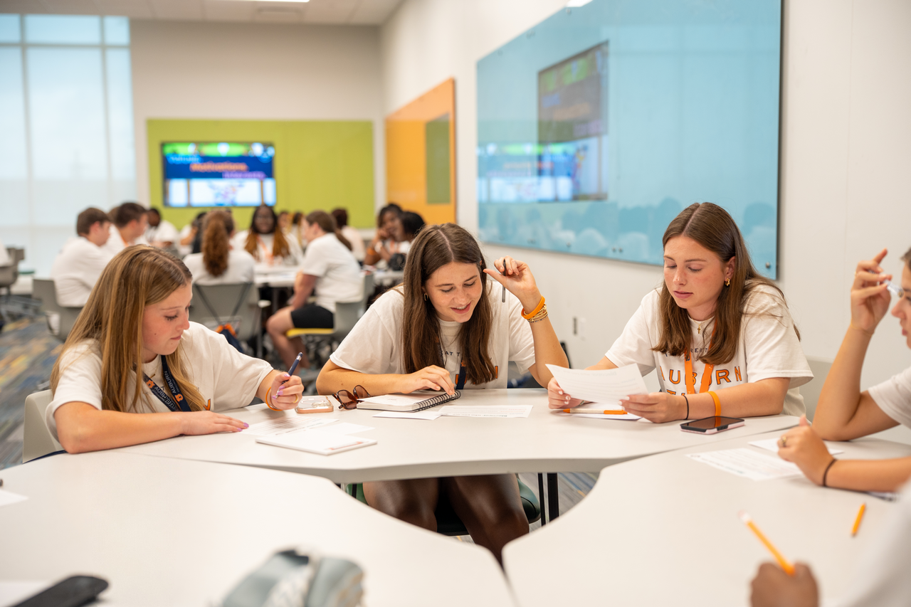 A classroom filled with students working on a group project.