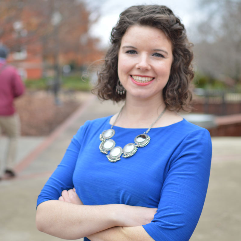 Chaffin Hart with arms folded in a royal blue dress.