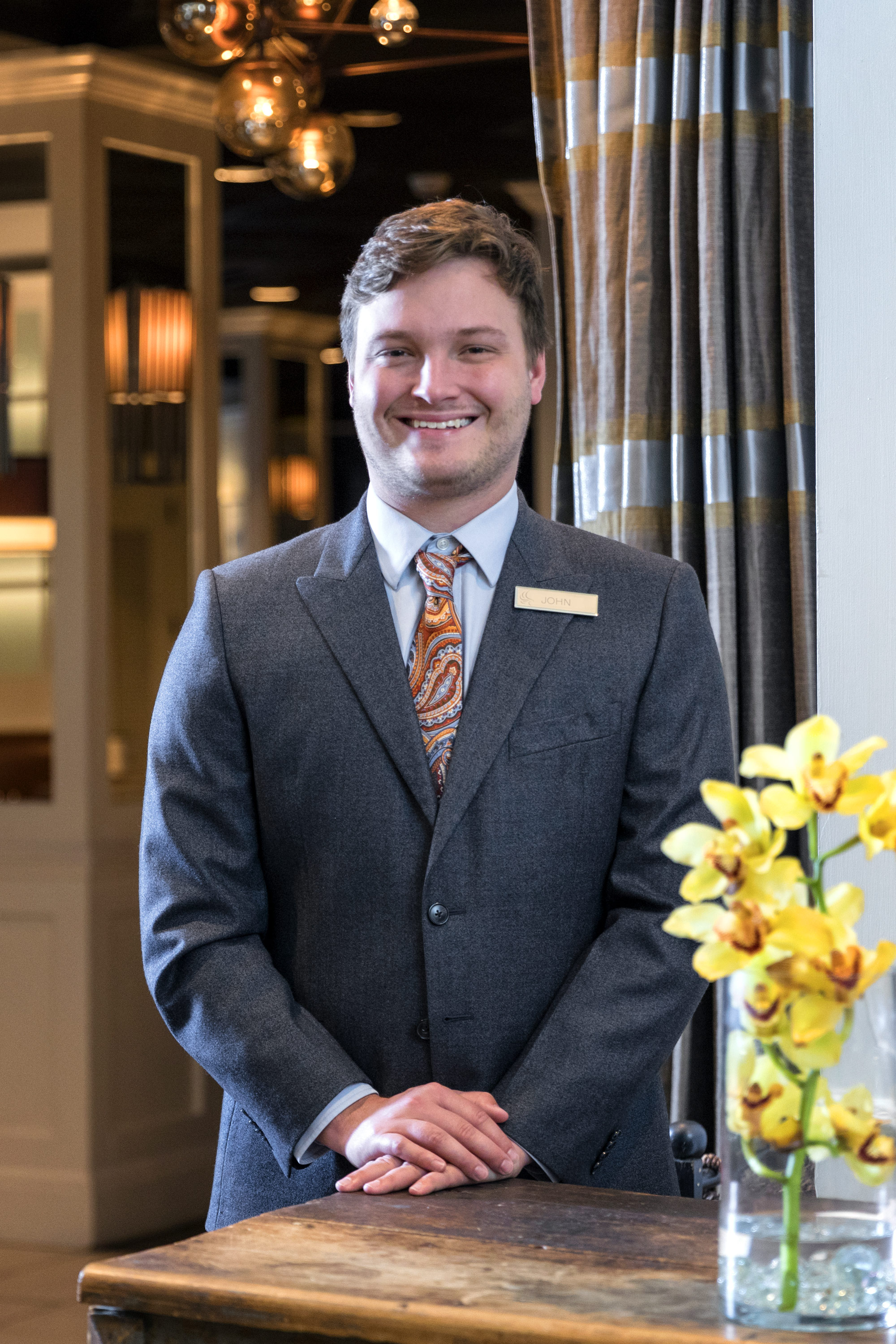 Intern in lobby of Auburn University Hotel 7 Conference Center