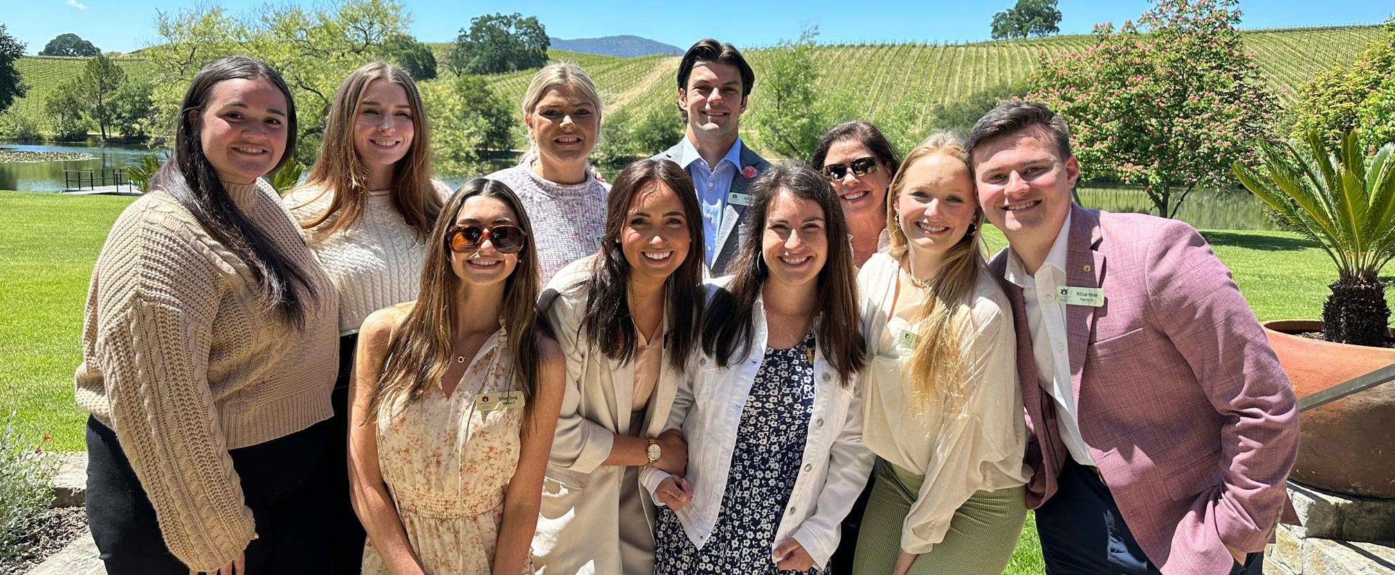 Photo of students with a grapevines in the background.