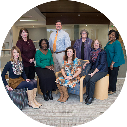 Eight people pose for a photograph.