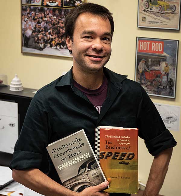 A man holds two books