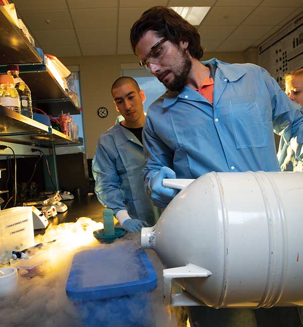 A man pours a cold liquid from a tank