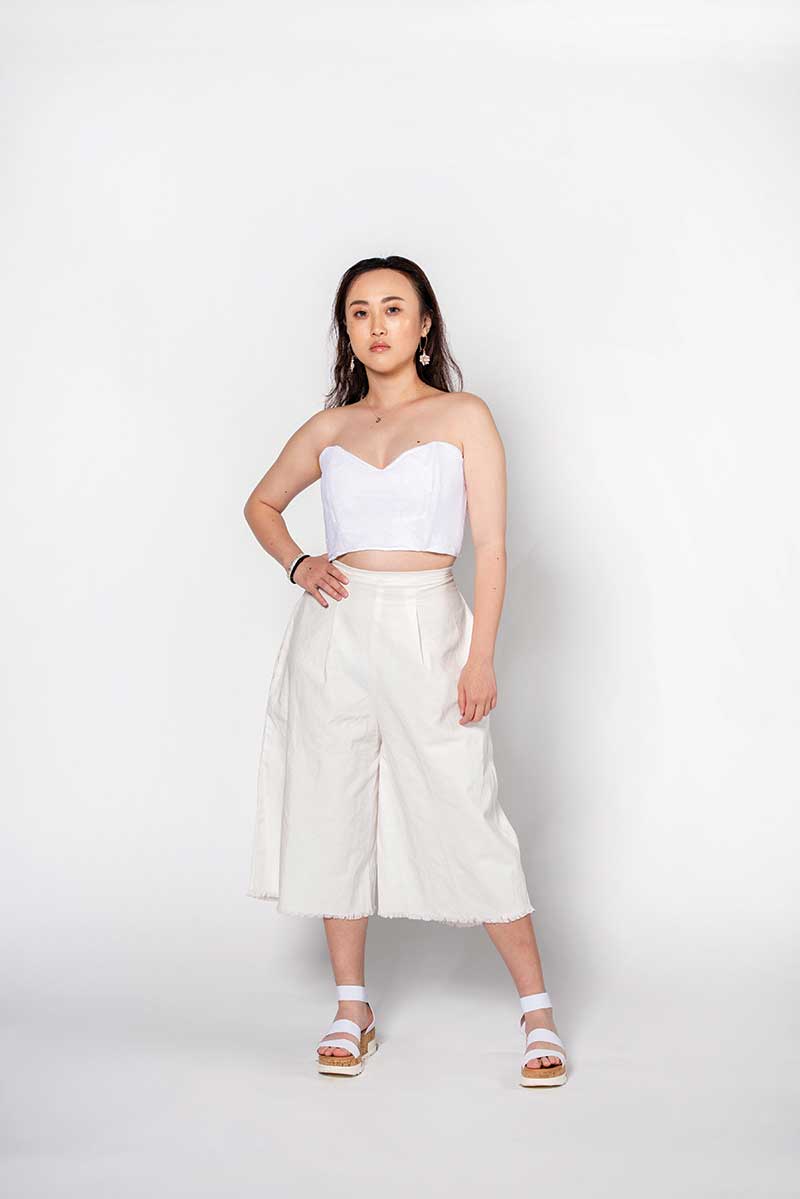 A model in a white dress poses