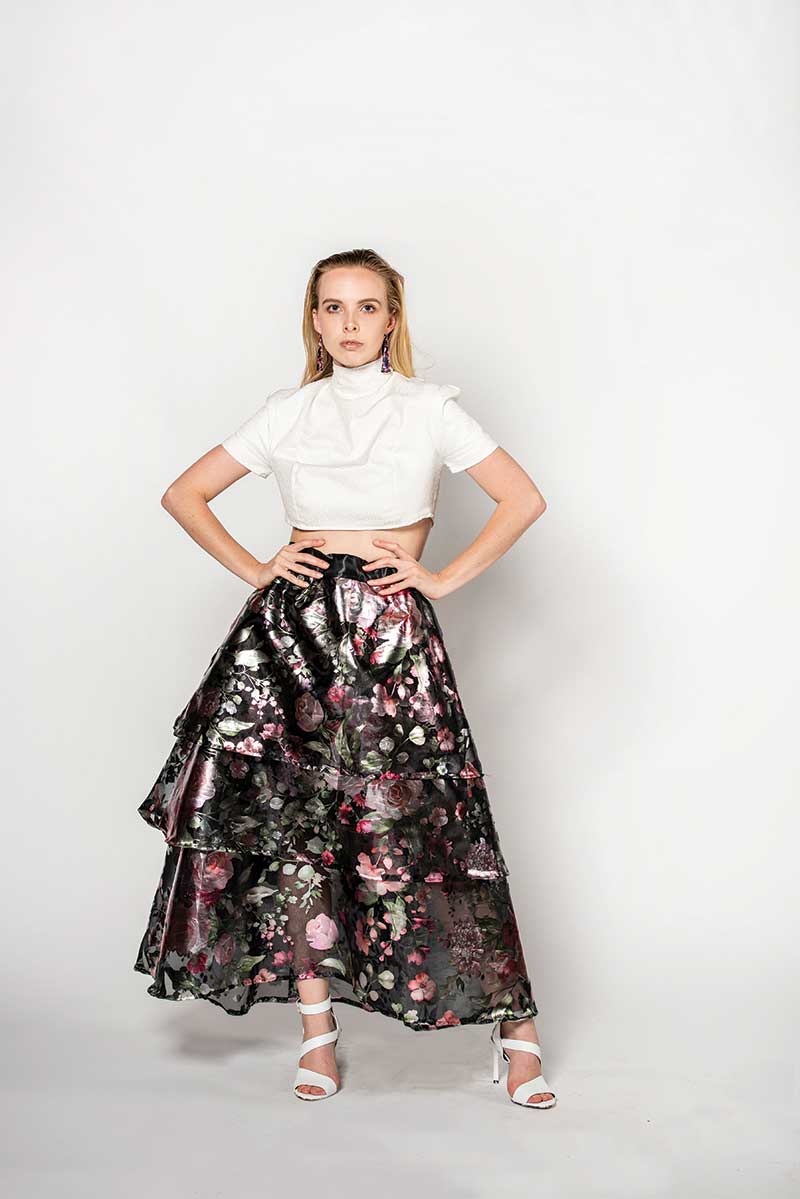A model in a multi-colored dress poses