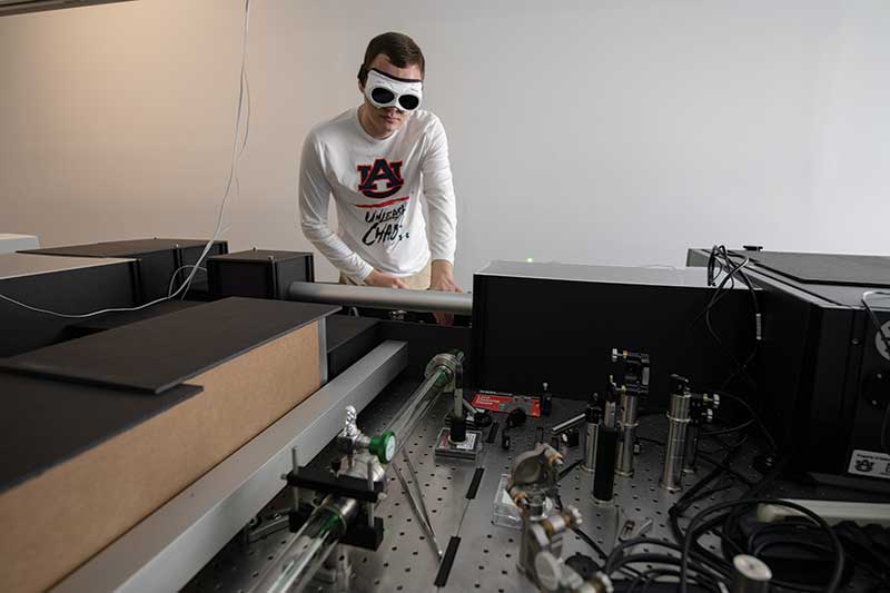 A student works while wearing seeing protection