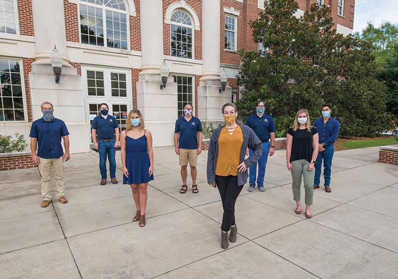 A research team stands outside