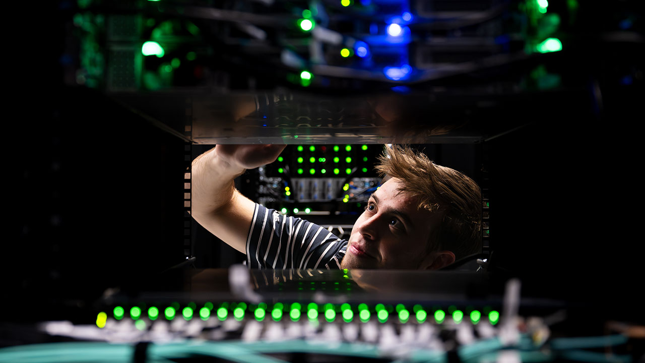 A person works on a computer station