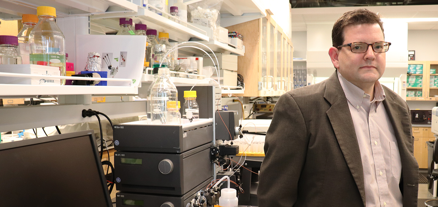 Peter Panizzi stands in his lab