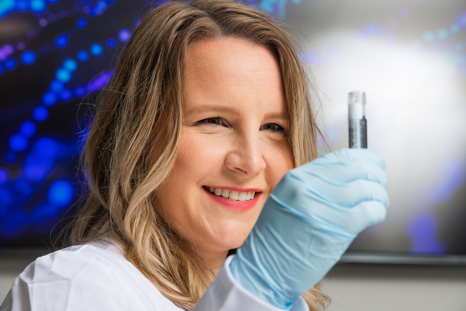 Dr. Alexander holds up a test tube