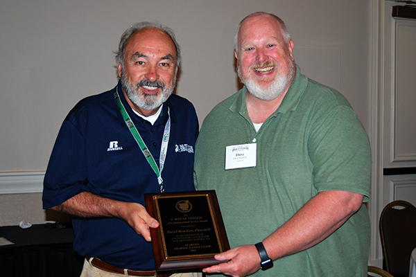 Buddy Bunch and Dave Brackett hold the award