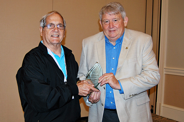 Danny Cottrell and Charles Sands hold the award