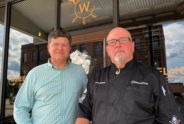 Merrill Culverhouse and Jon Gibson stand outside restaurant