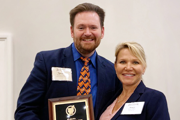 Spencer Durham and Stacie Giles hold the award