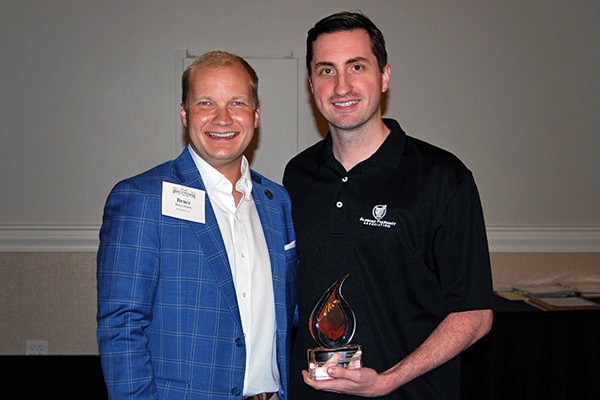 Bruce Harris and Grant McGuffey hold the award