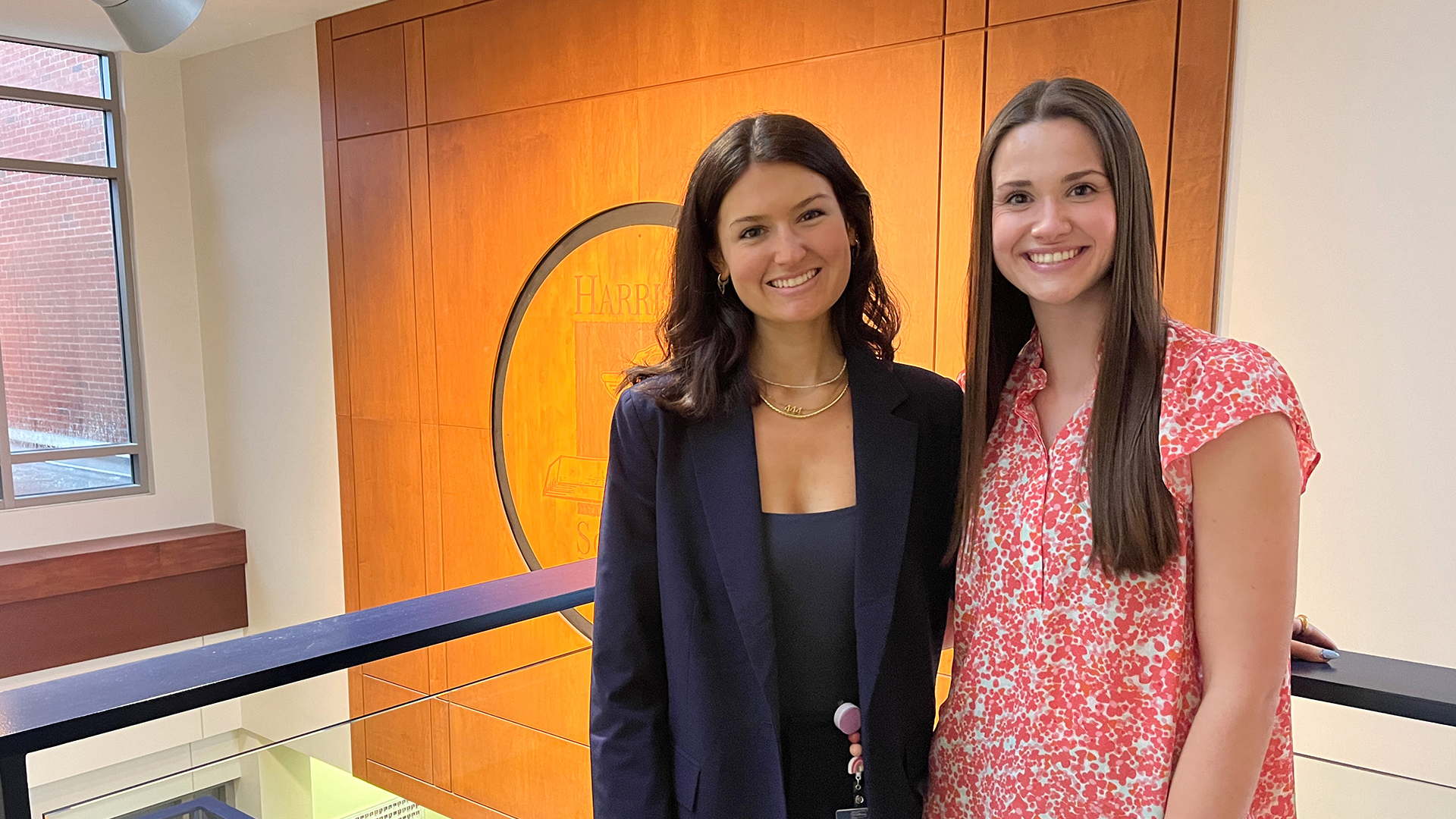 Lucy Tocco and Sydney Helms stand in the Walker Building
