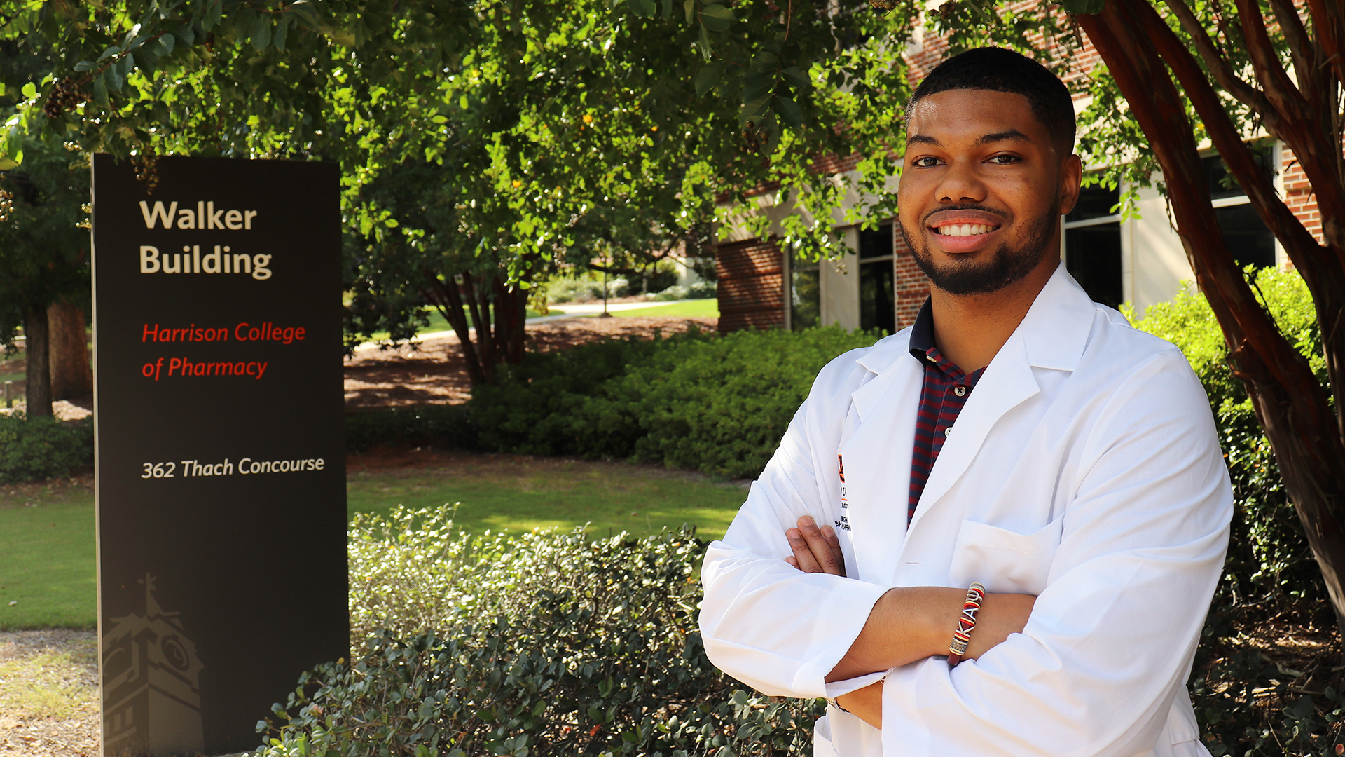 Miles Wiley stands next to HCOP sign
