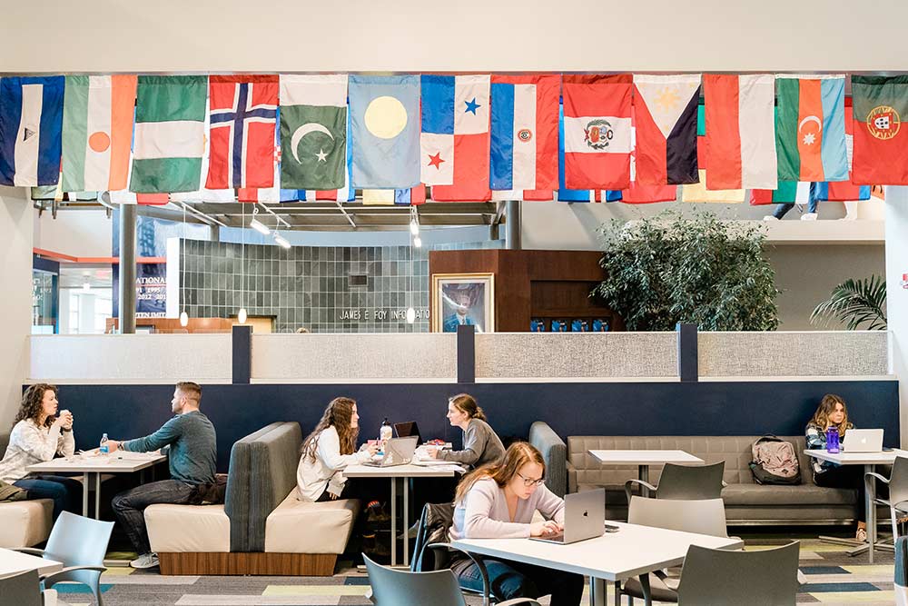 Students sitting at tables inside the Melton student center