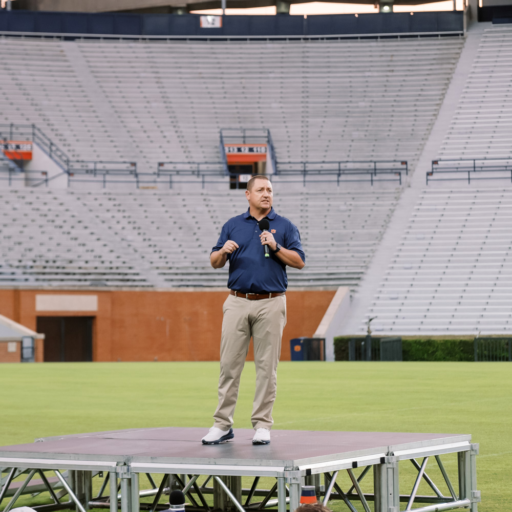 Bobby Woodard talking to students in Jordan-Hare Stadium