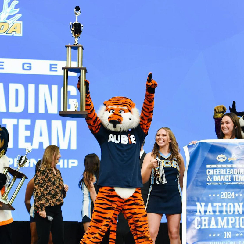 Aubie on stage with trophy after winning his 11th National Championship