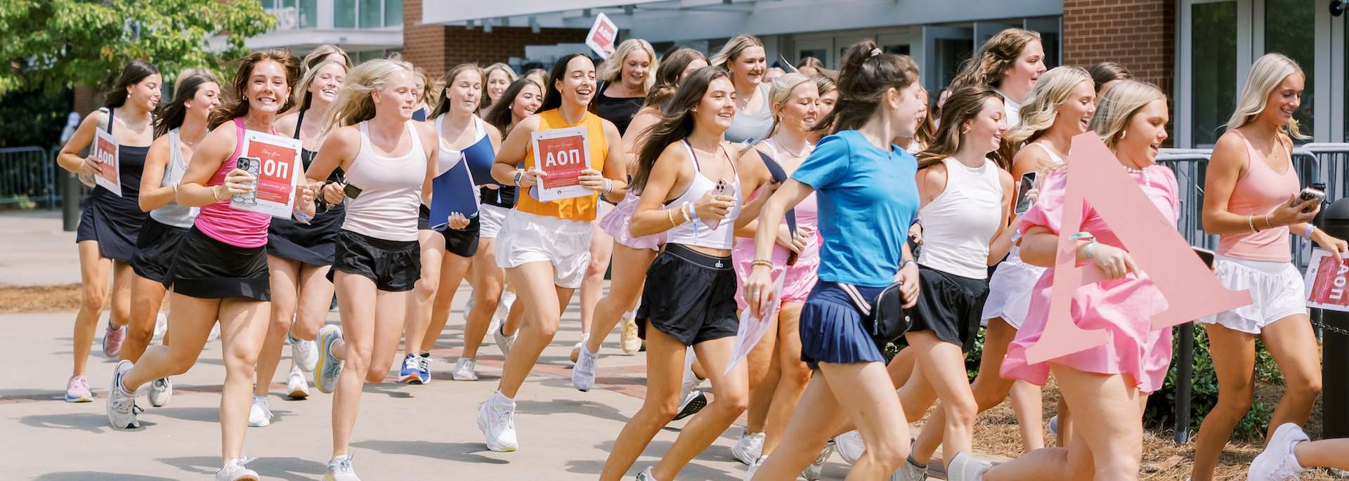 sorority students run out of Neville arena on bid day