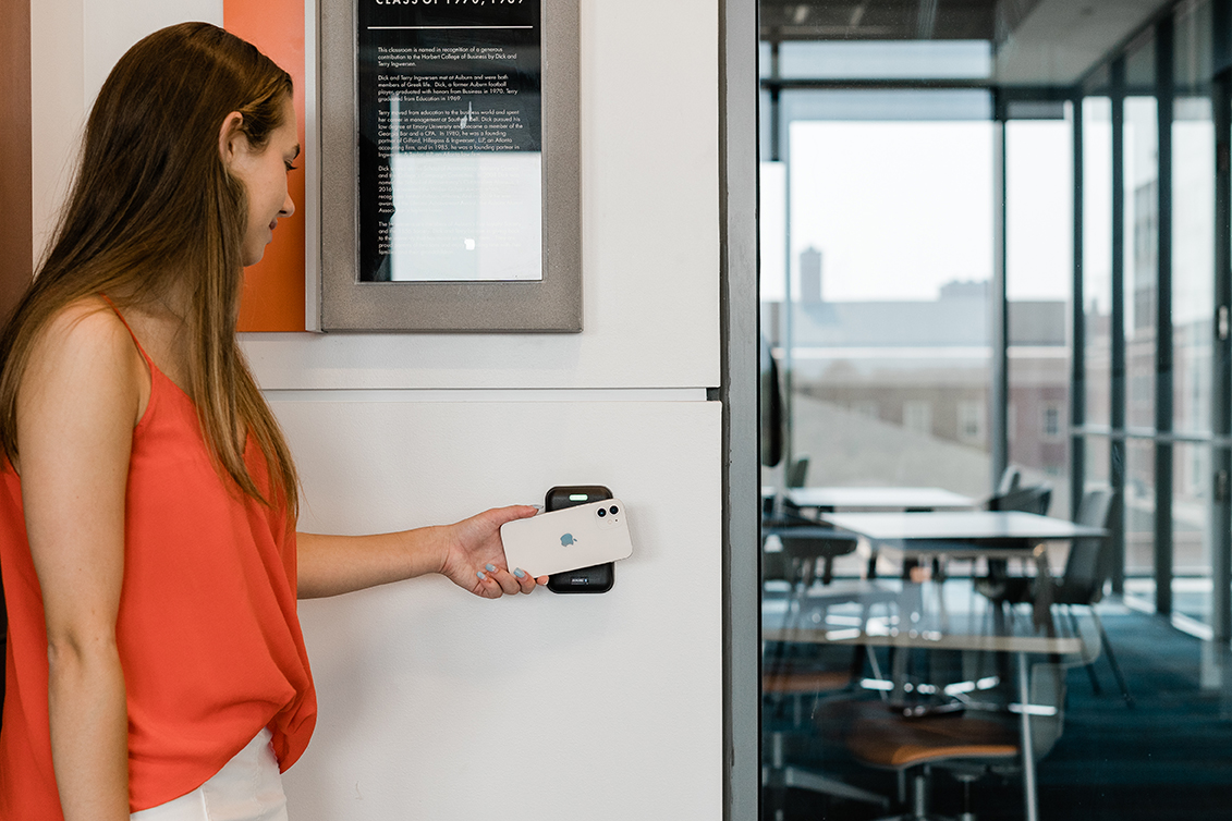 A places mobile device on contactless ID reader.